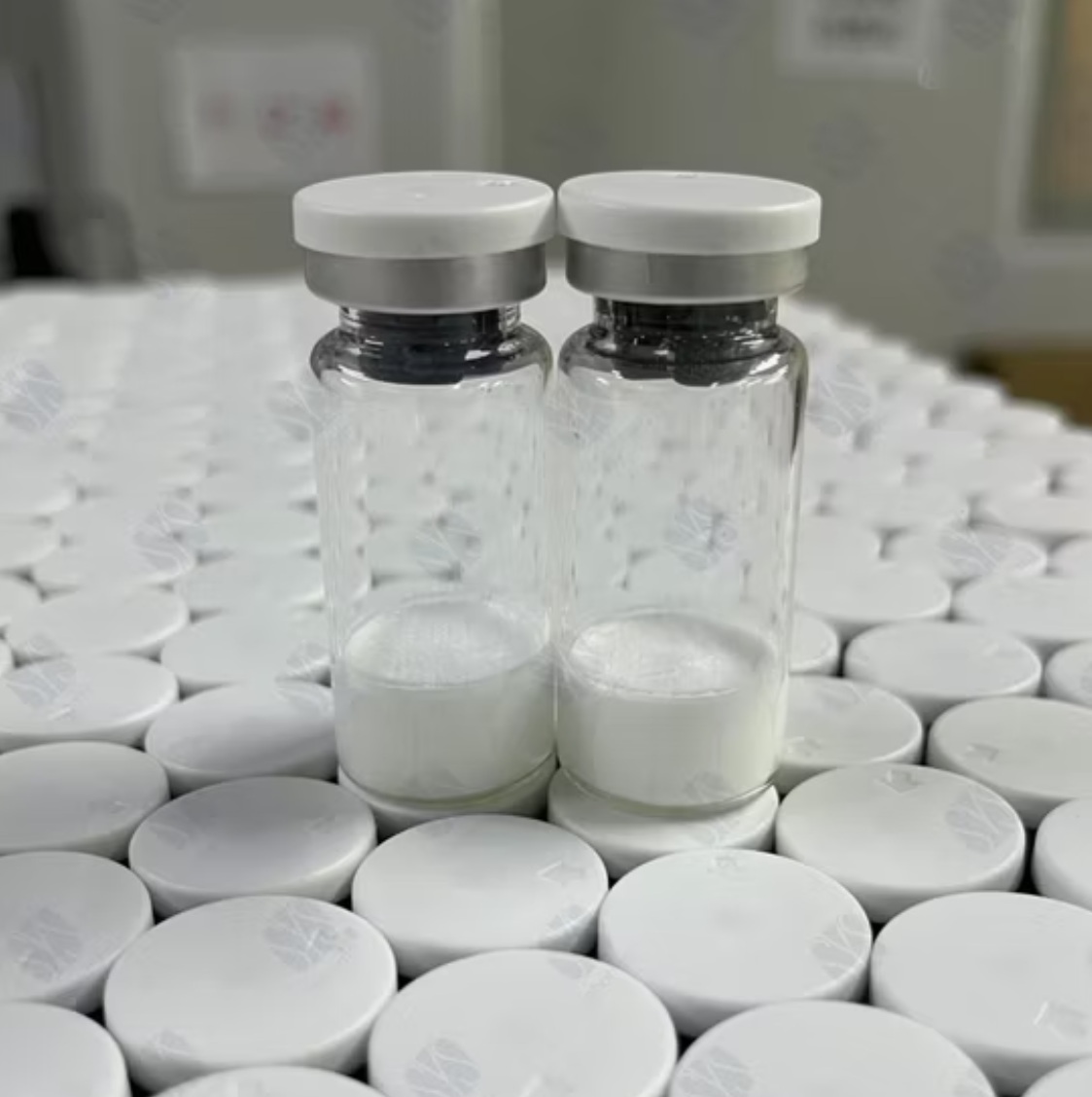 Plain unlabeled clear glass lyophilized vial with blue cap